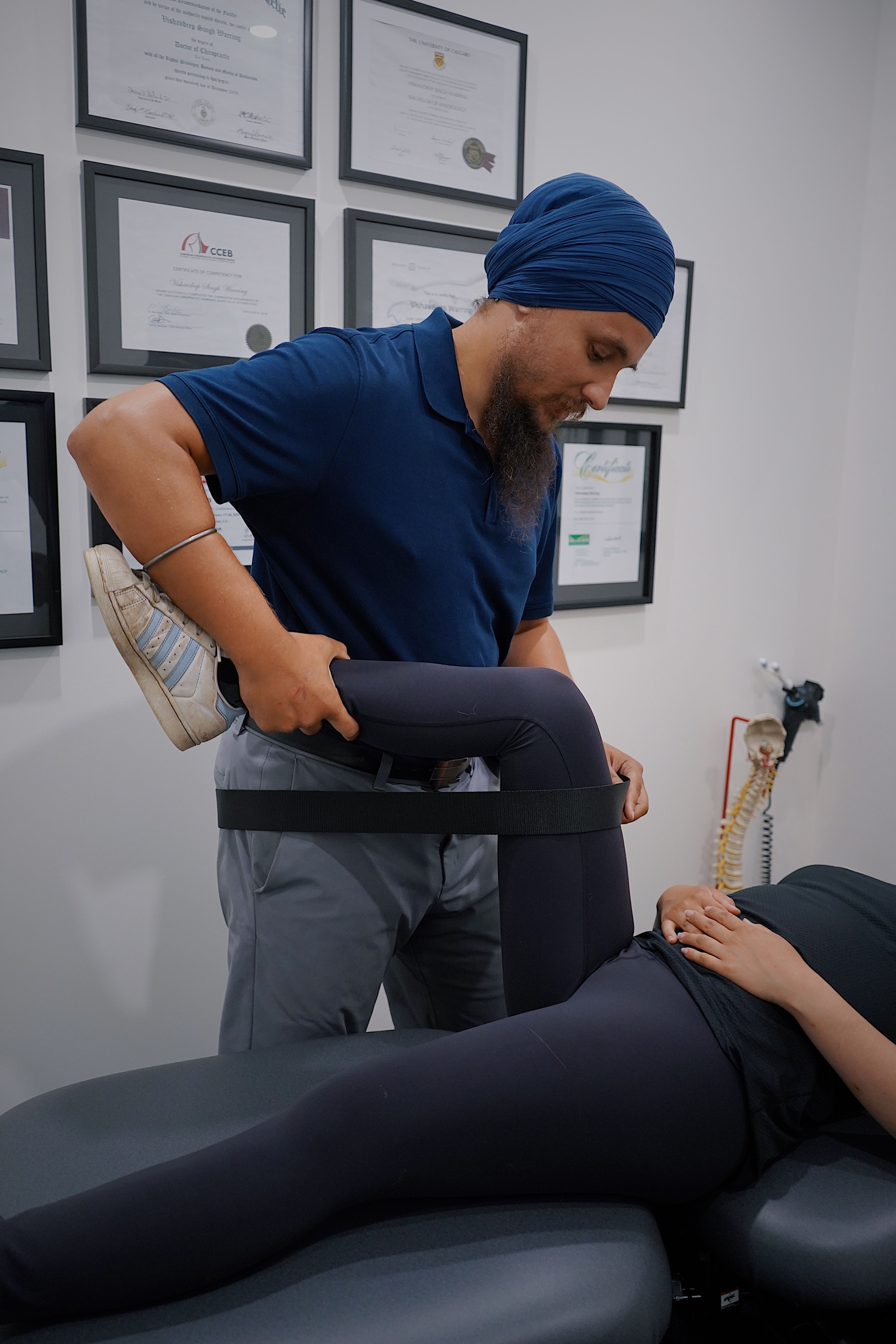 A physiotherapist guiding a patient through a leg rehabilitation exercise