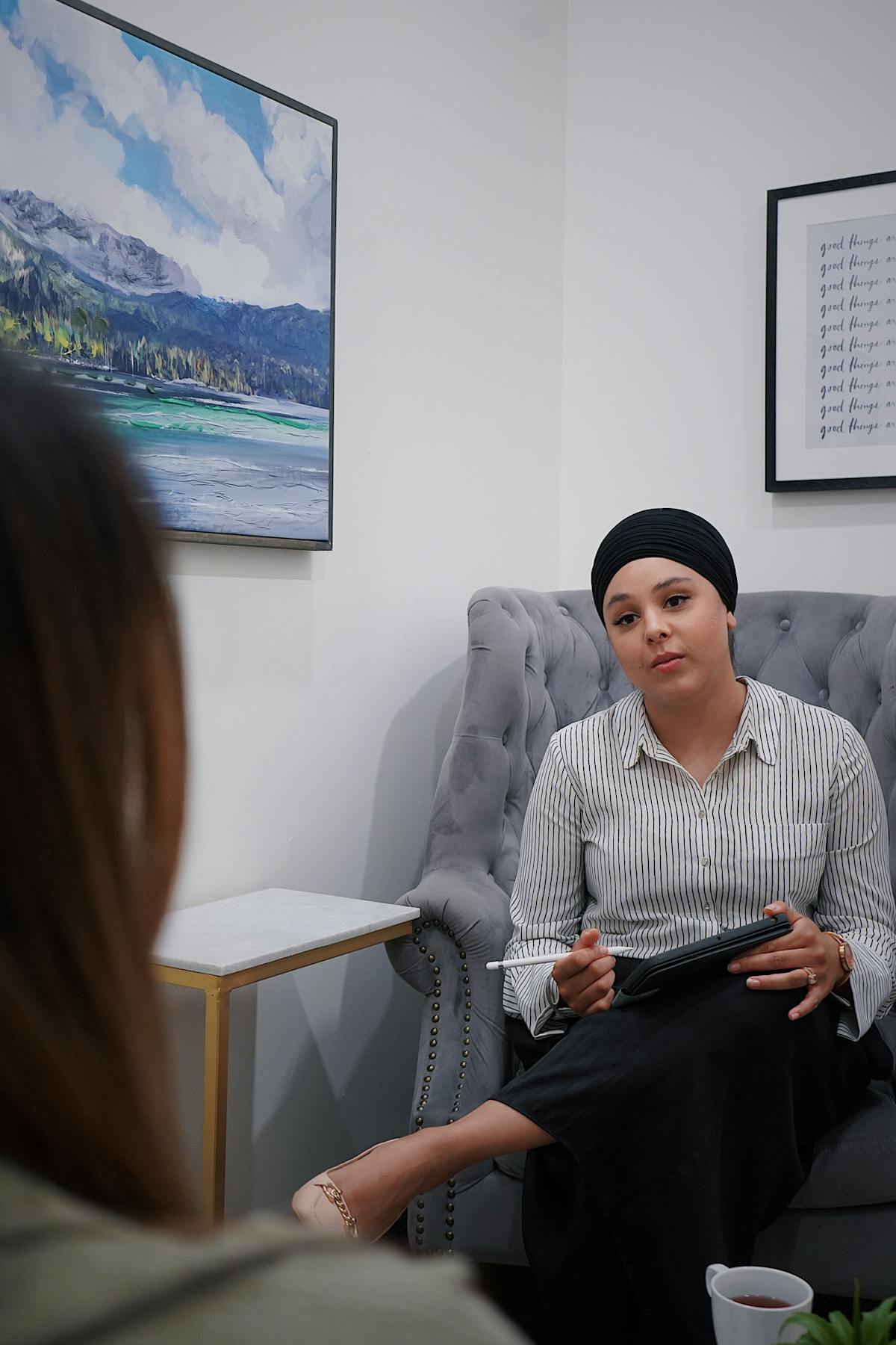 Therapy session in progress with therapist and client engaged in conversation