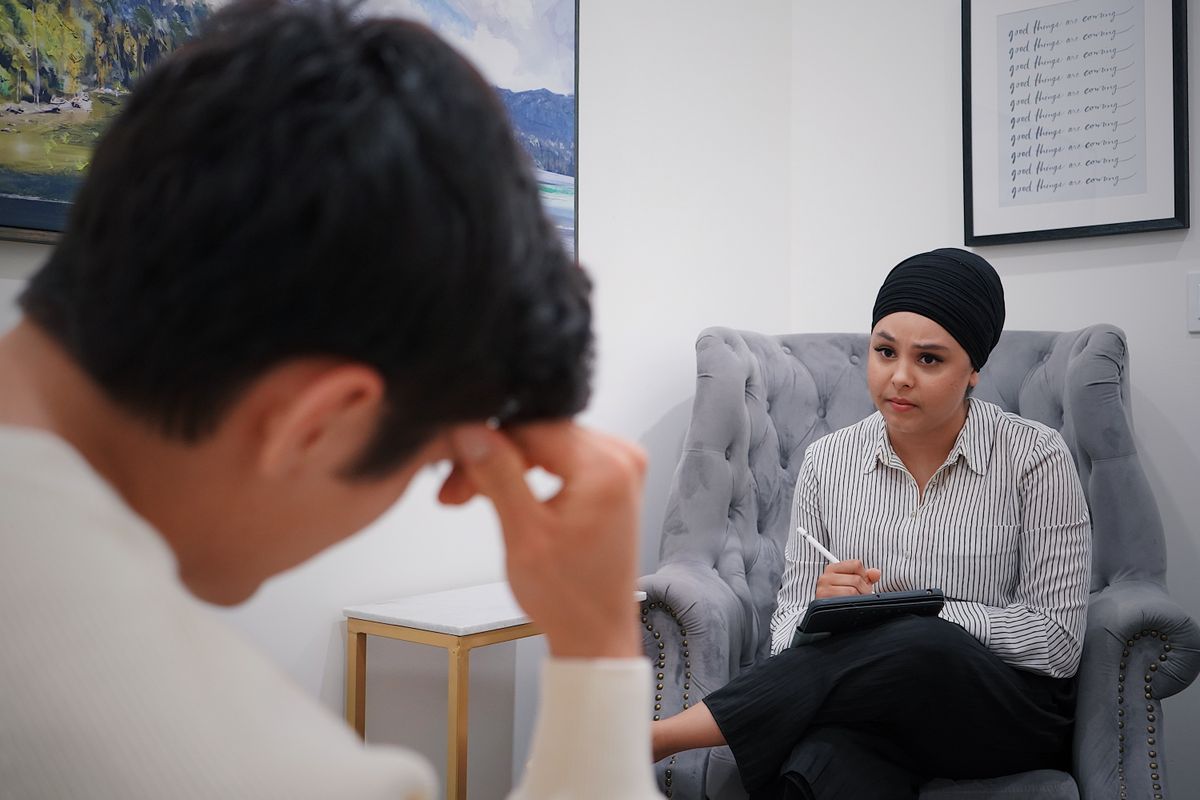 Psychiatric provider consulting with a patient