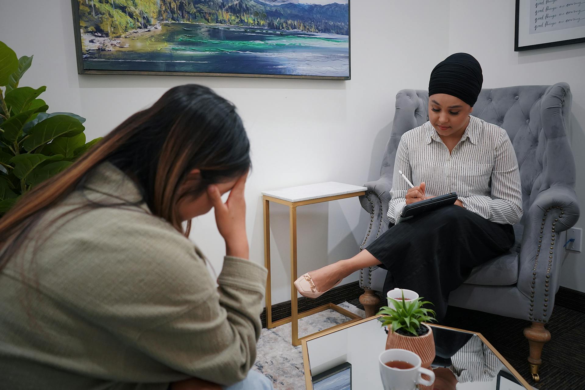 Two Women Sitting in a Room 