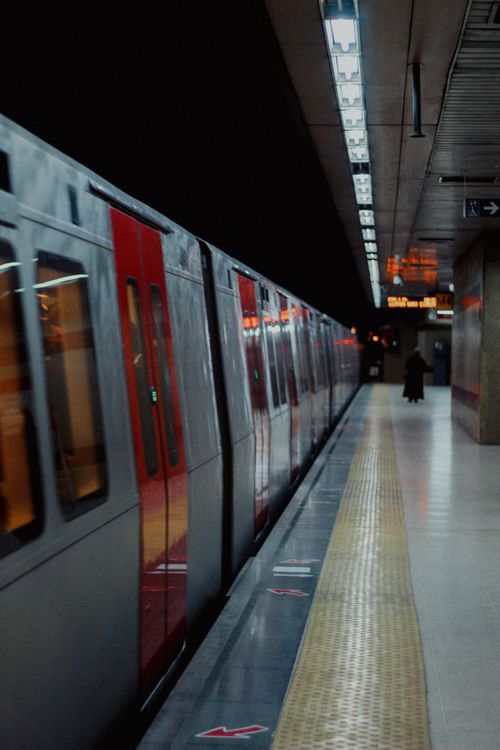 Free Dramatic capture of a subway train at an urban station platform at night. Stock Photo