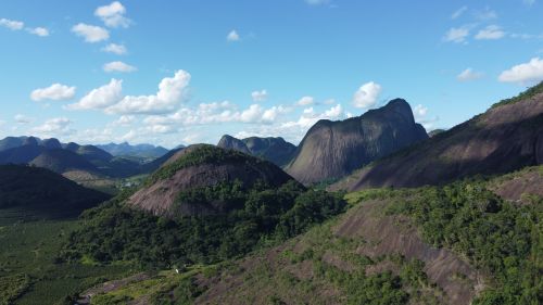 Free Breathtaking aerial view of Águia Branca's lush, green landscape and towering mountains. Stock Photo