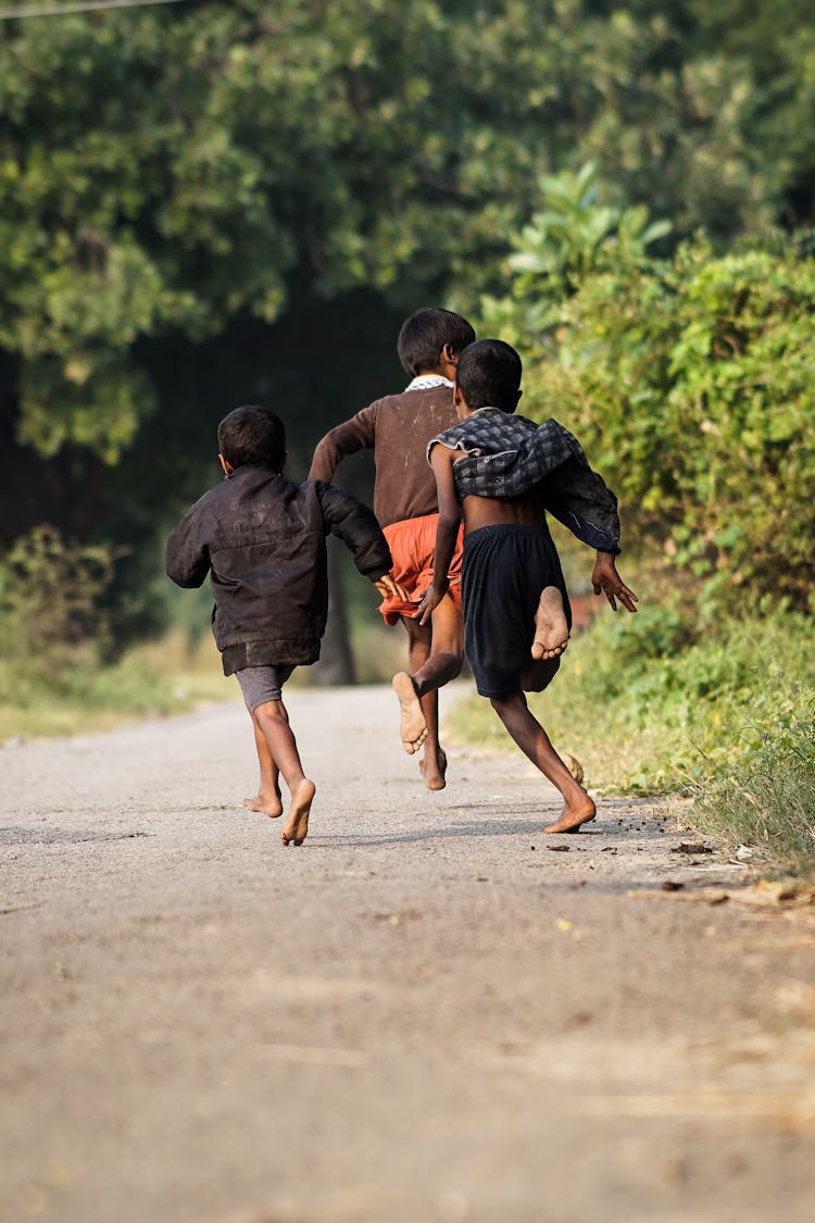 Back View Of Barefooted Kids Running 