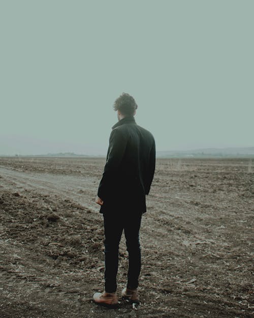 A Man Standing in a Field 