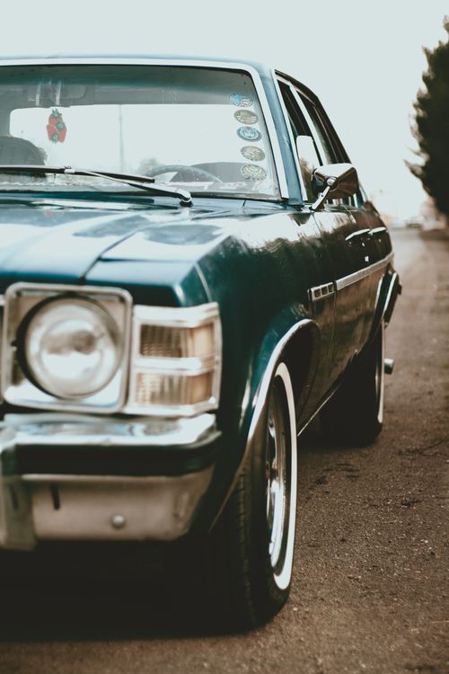 Free Close-up shot of a vintage green Buick Skylark vehicle parked outdoors. Stock Photo