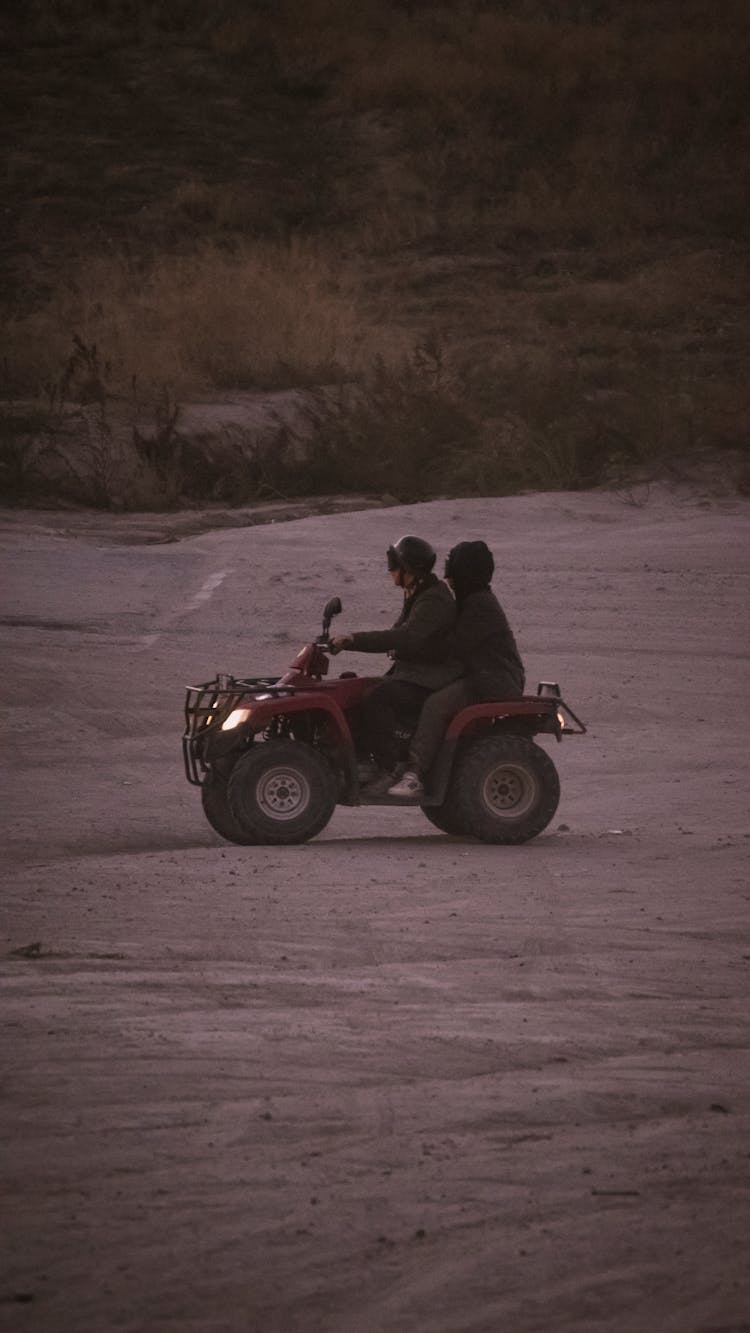 A Couple Riding An ATV