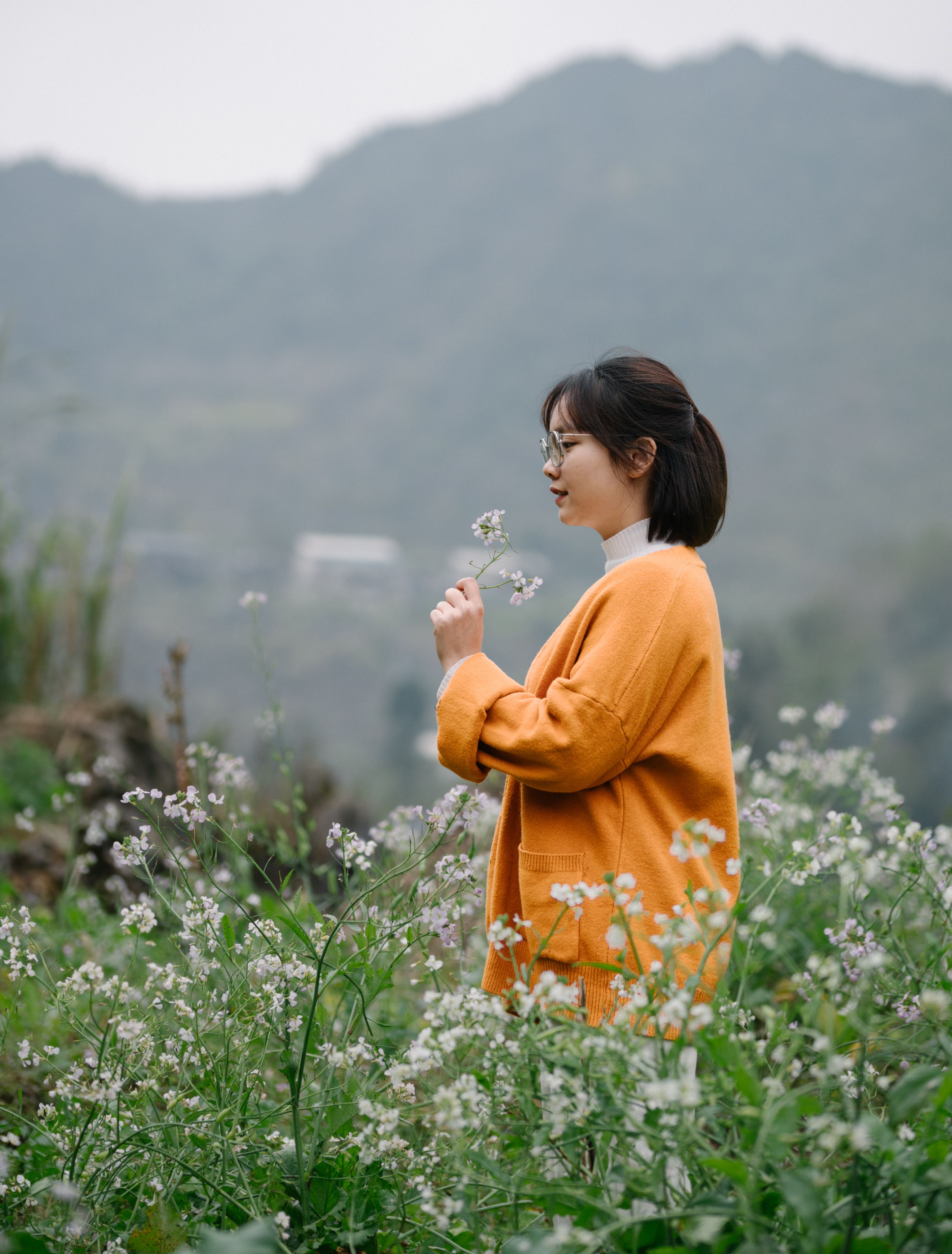 A Woman with a Flower in a Field · Free Stock Photo