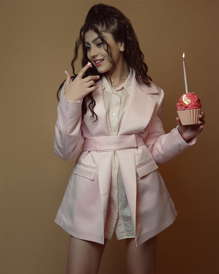 Woman In Pink Clothes Holding A Cupcake