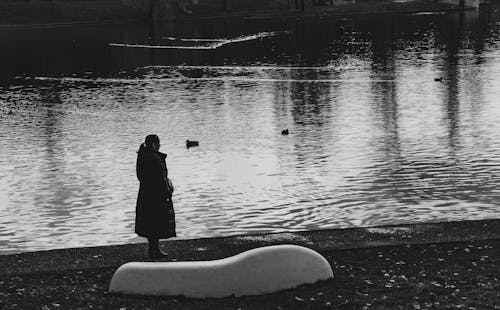 Woman Standing near Water in Black and White
