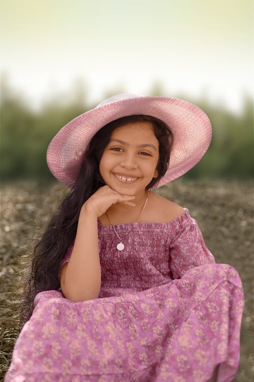 A Cute Girl in Purple Floral Dress Smiling