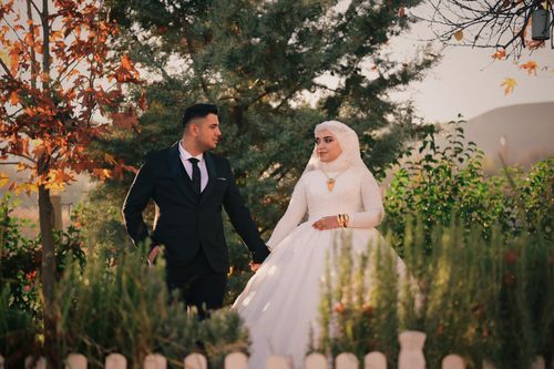Free A newlywed couple in Adıyaman, Turkey, shares a serene garden moment. Stock Photo