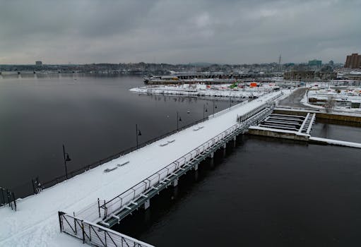 Aerial view of a snowy harbor in Ottawa, showcasing winter in the city with cloudy skies.