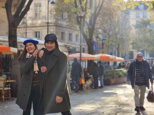 A Happy Couple Walking on an Alley in City 