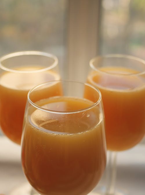Close-Up Photograph of Glasses with Juice