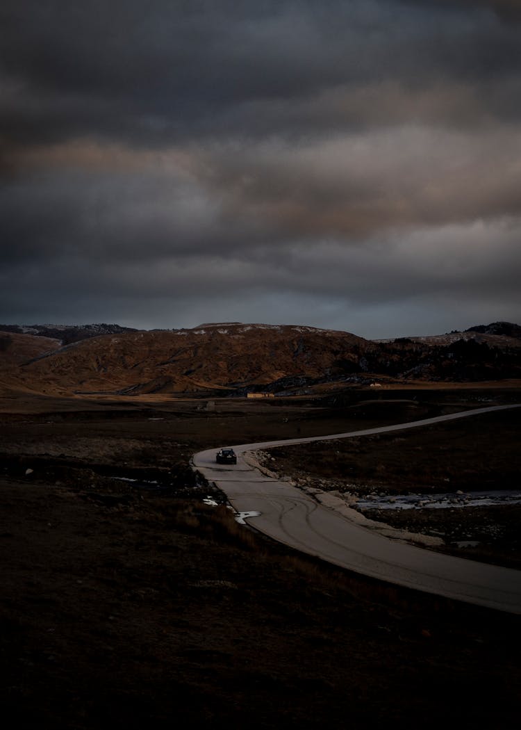 Car On The Road Near The Mountains