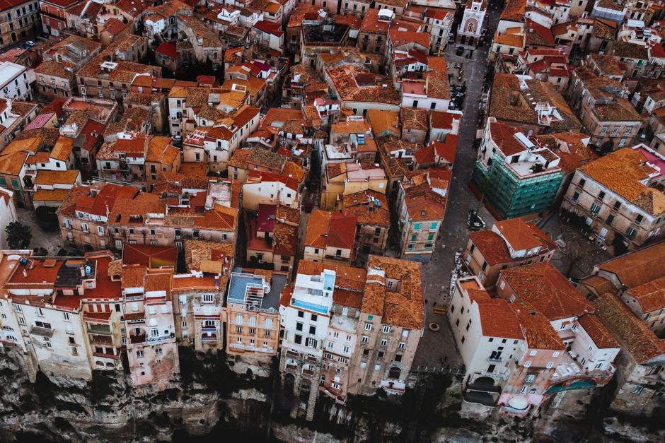 Bird's eye view of colorful rooftops in the historic town of Tropea, Italy.