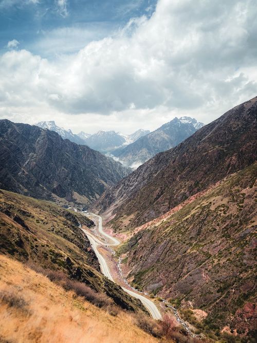 Free Discover the breathtaking winding road through the mountains of Chuyskoe, Kyrgyzstan, depicted in this stunning landscape photo. Stock Photo