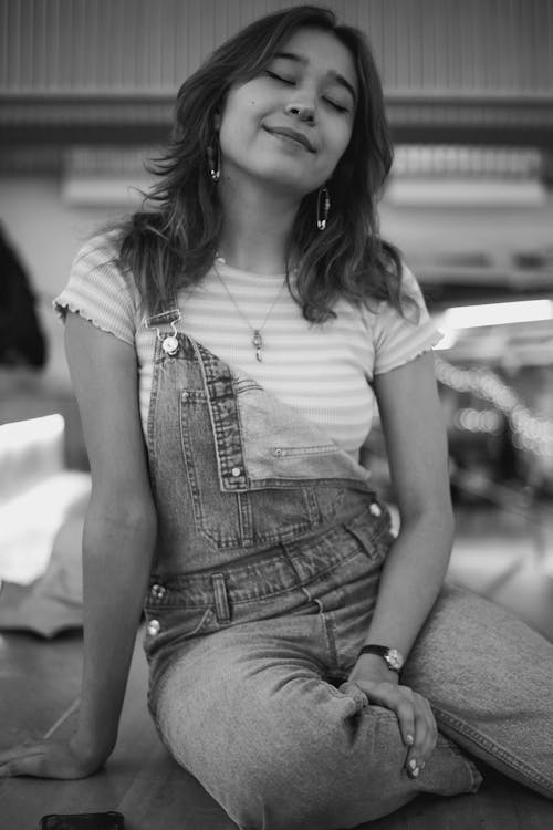 Grayscale Photo of a Woman in Overalls 