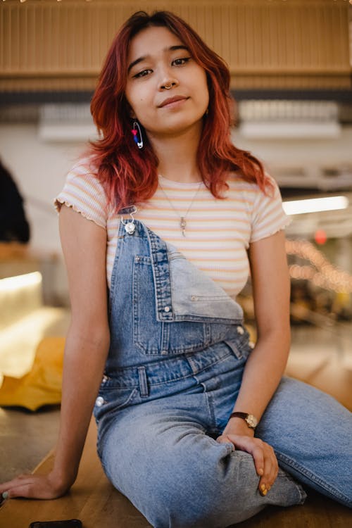 A Woman with a Nose Piercing Wearing a Denim Jumper