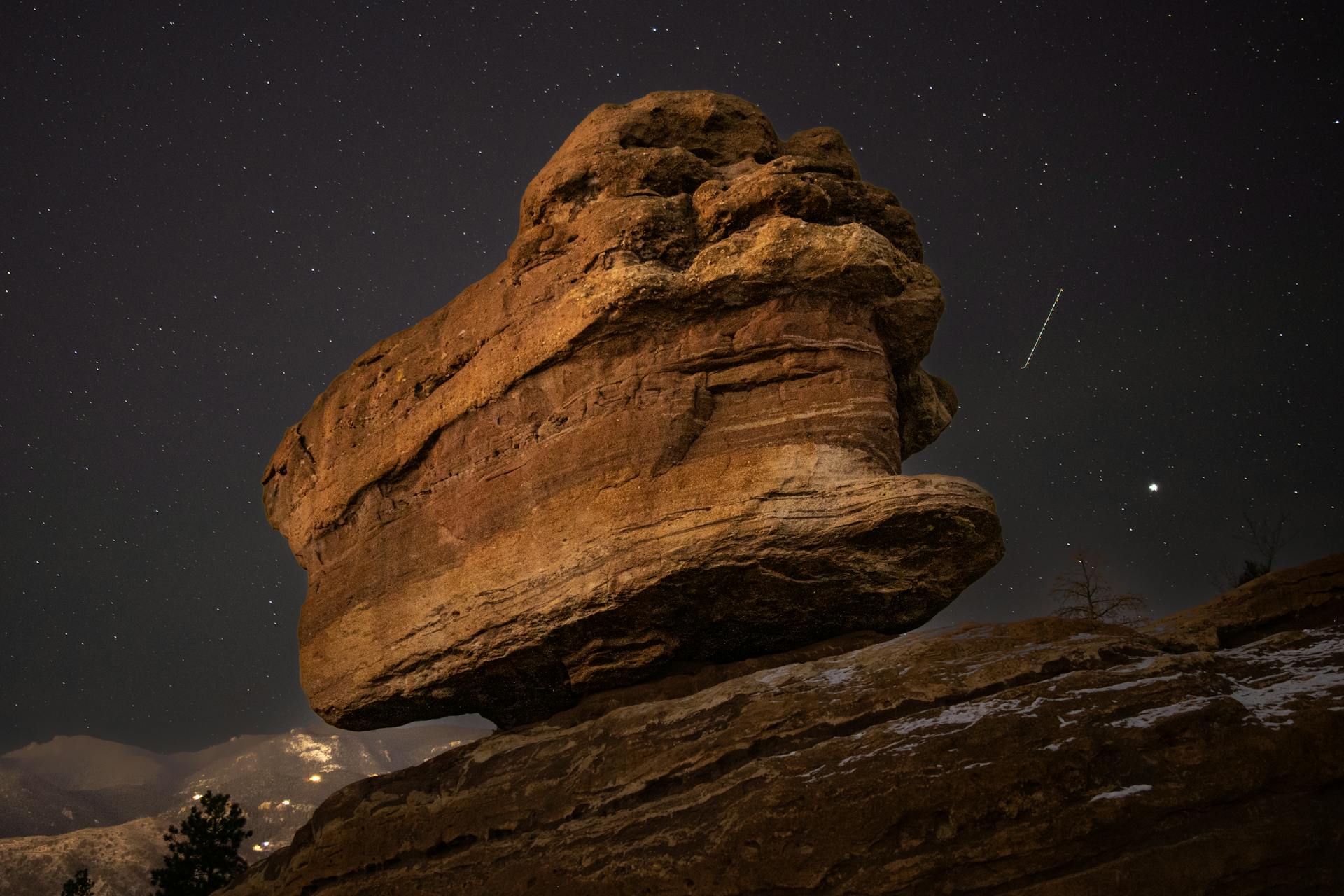 A striking view of Balanced Rock in Colorado Springs against a starry night sky.