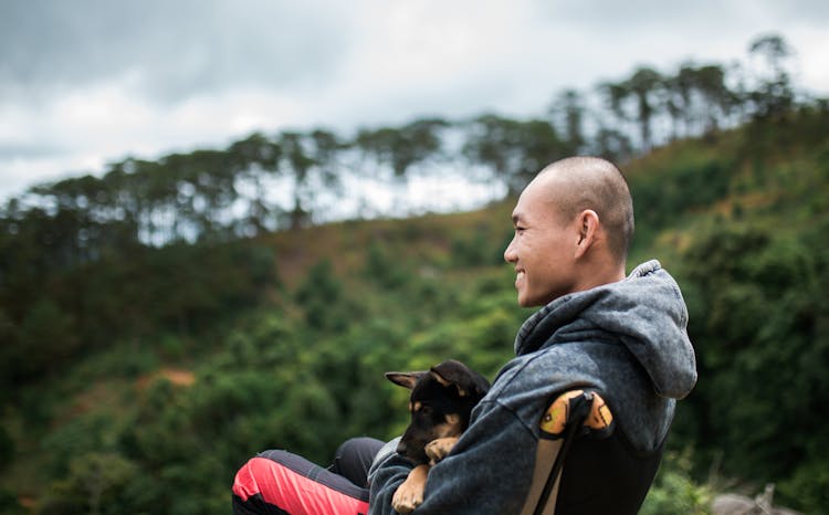 Bald Man Holding A Dog