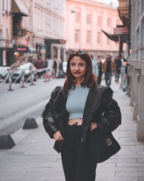 Portrait of a Pretty Brunette Standing on a Sidewalk