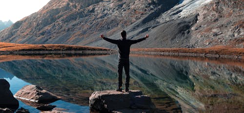 Photo of Man standing on a Rock