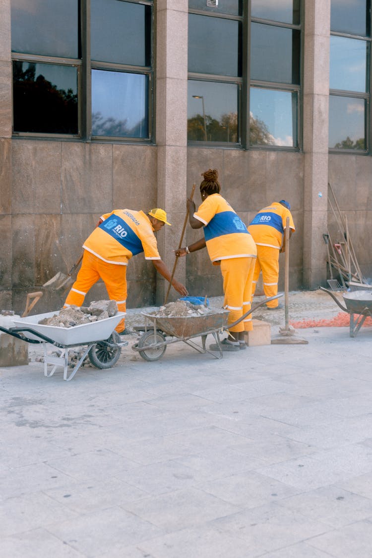 Construction Workers Cleaning The Side Of The Building 