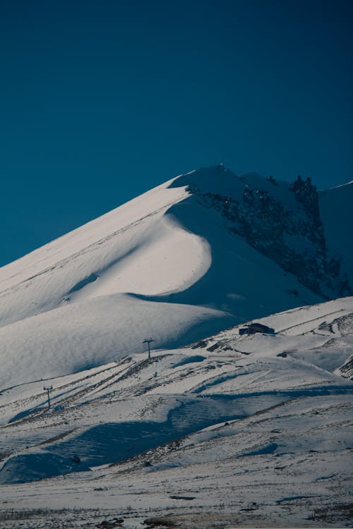 Sunlit Mountain Peak During Winter