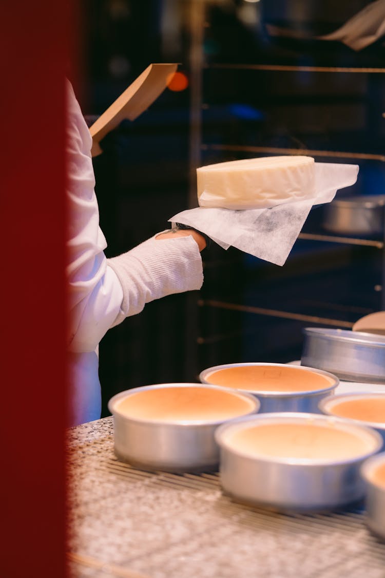 Person Holding Food On Baking Paper