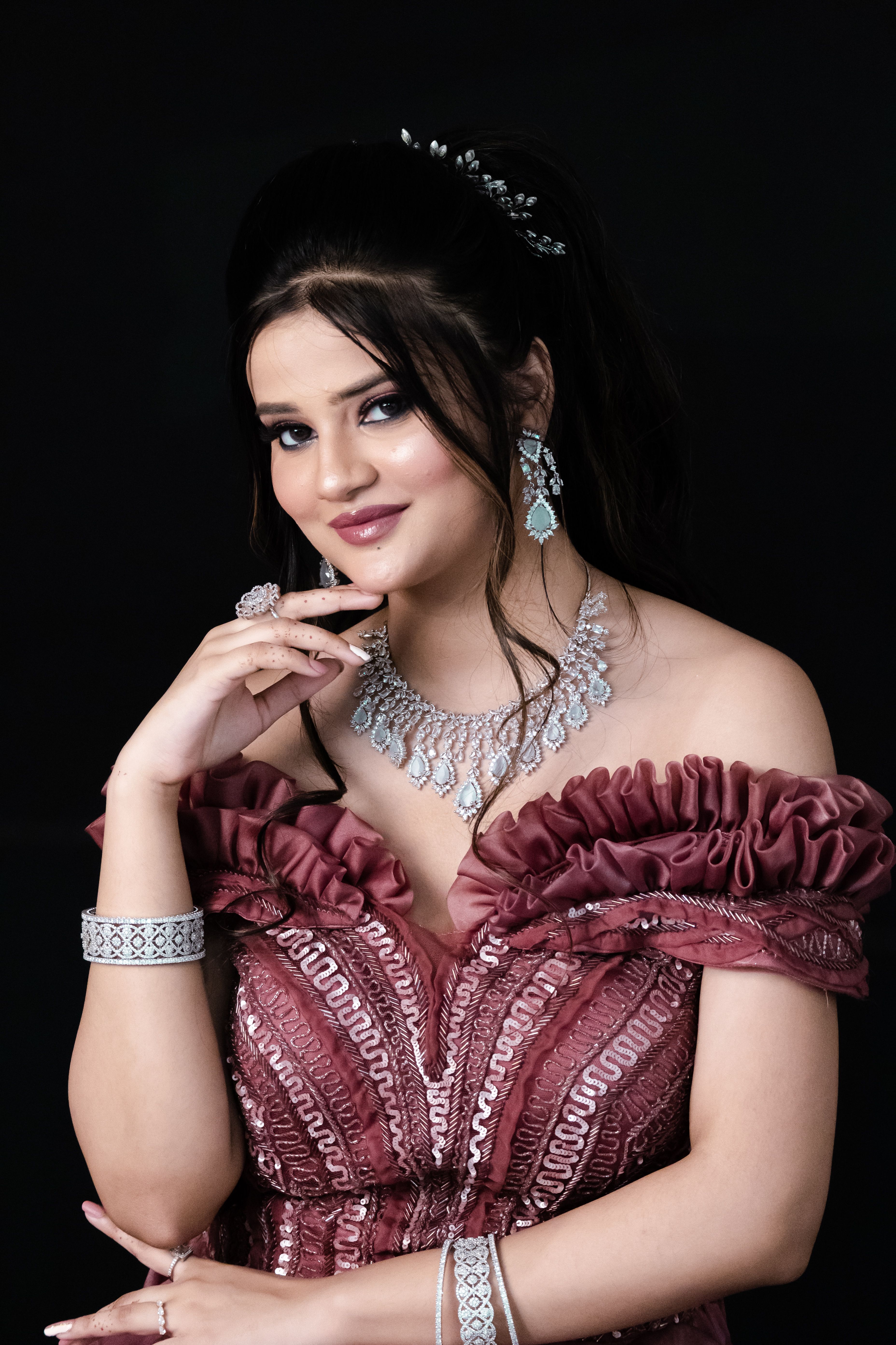 Portrait of a woman in a pink gown wearing elegant jewelry