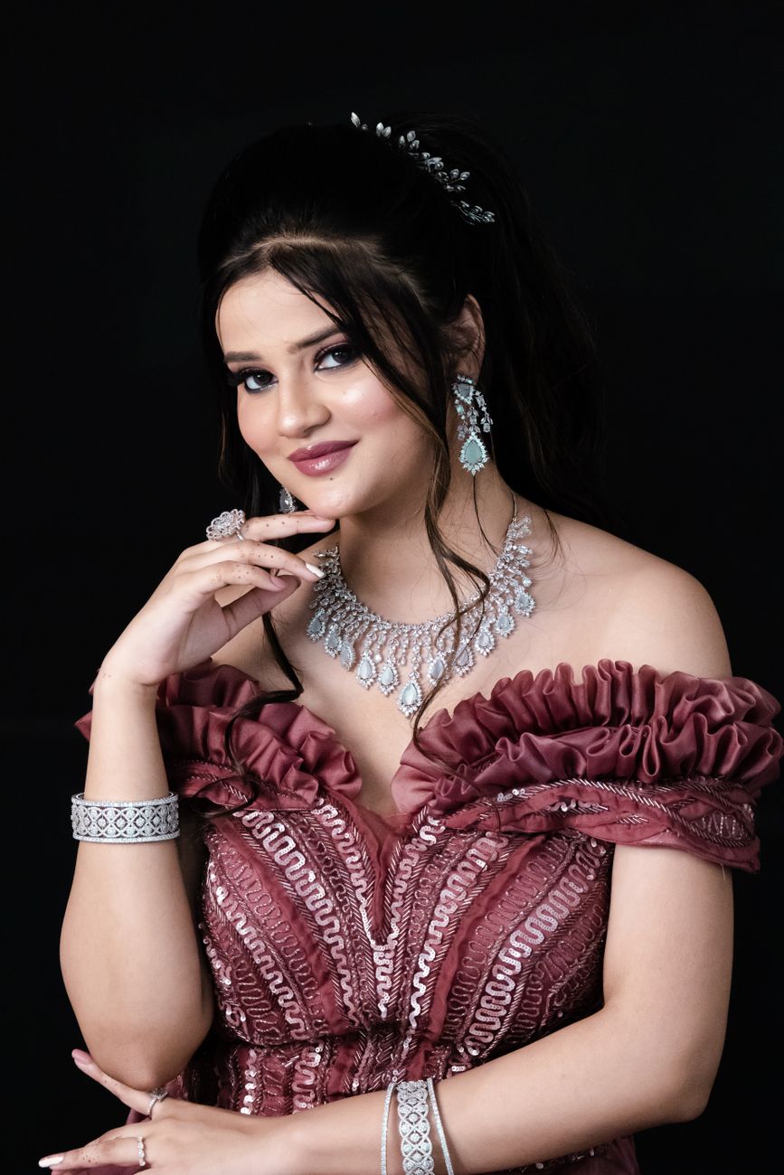 Portrait of a woman in a pink gown wearing elegant jewelry
