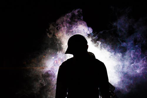 Silhouette Photography of Smoke Behind Person