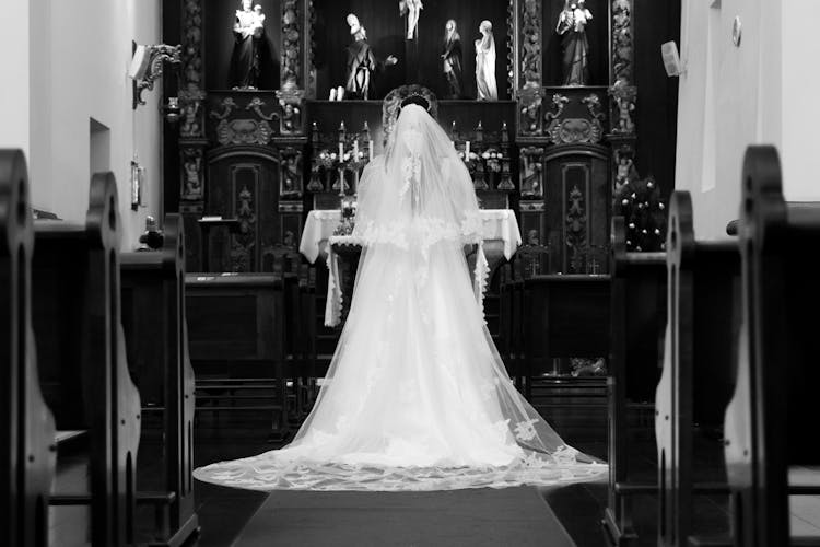 Grayscale Photo Of A Bride At The Altar