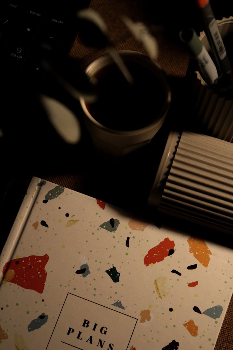 Journal And Cups On A Desk 