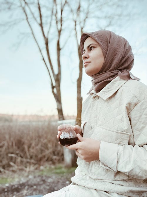 A Woman in Hijab Holding a Drink