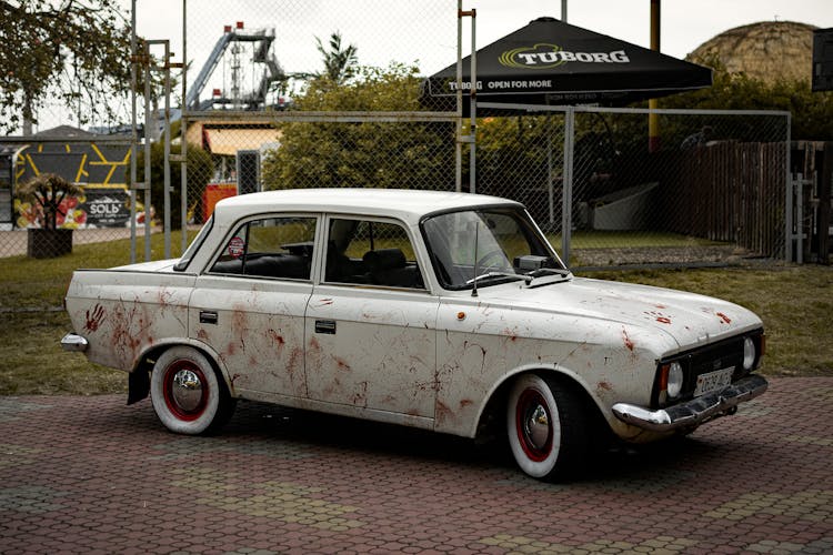 Side View Of A Dirty White Car 