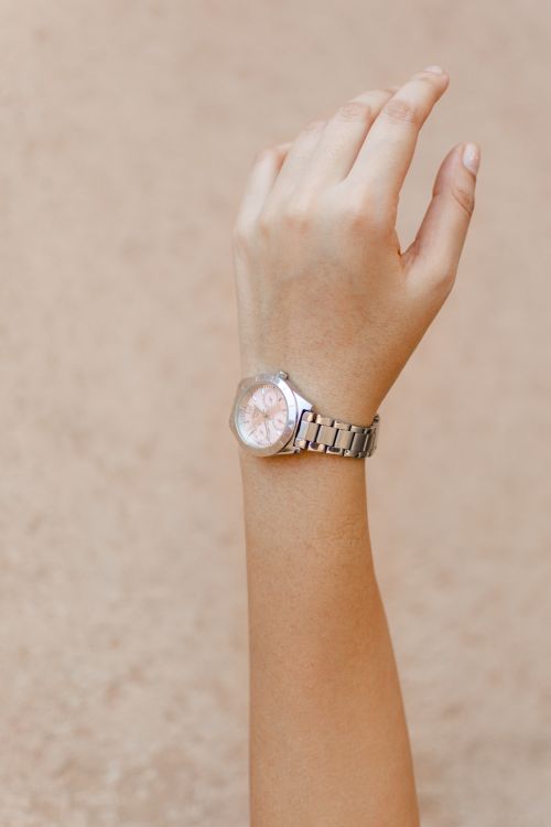 Free Close-up shot of a woman's hand wearing an elegant wristwatch, showcasing minimalist design and style. Stock Photo