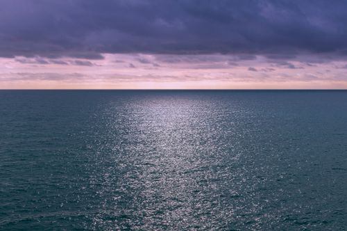 Free A breathtaking view of the sea under a purple, cloudy sky during sunset in Sitges, Spain. Stock Photo