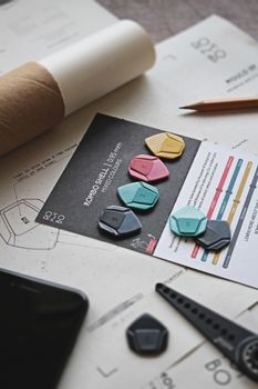 Various colored guitar picks arranged on a music sheet with design elements.