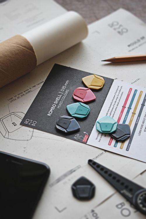 Free Various colored guitar picks arranged on a music sheet with design elements. Stock Photo