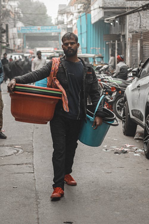 Man Selling Plastic Buckets and Basins