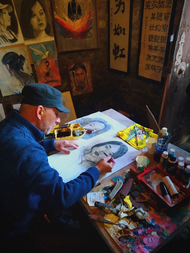 Male Artist Painting A Woman