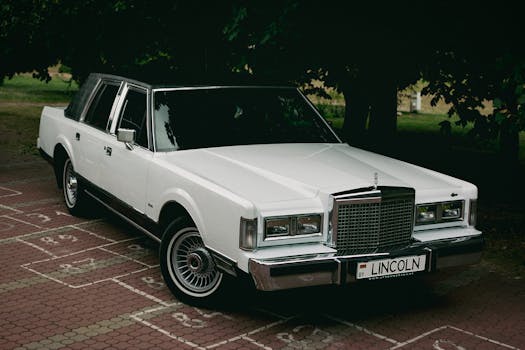 Vintage white Lincoln limousine parked in a serene Minsk park.
