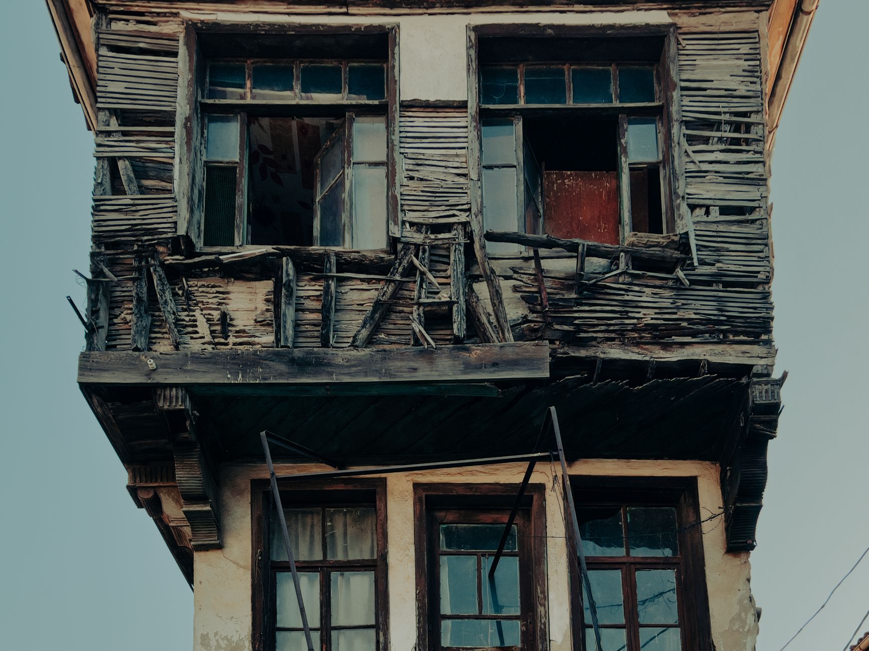 A decaying wooden house facade displaying rustic architecture in Mudanya, Turkey.