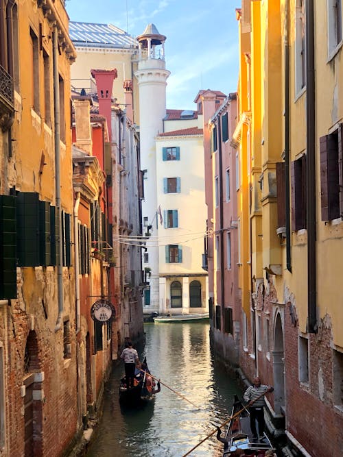 Gondoliers on Canal in Venice