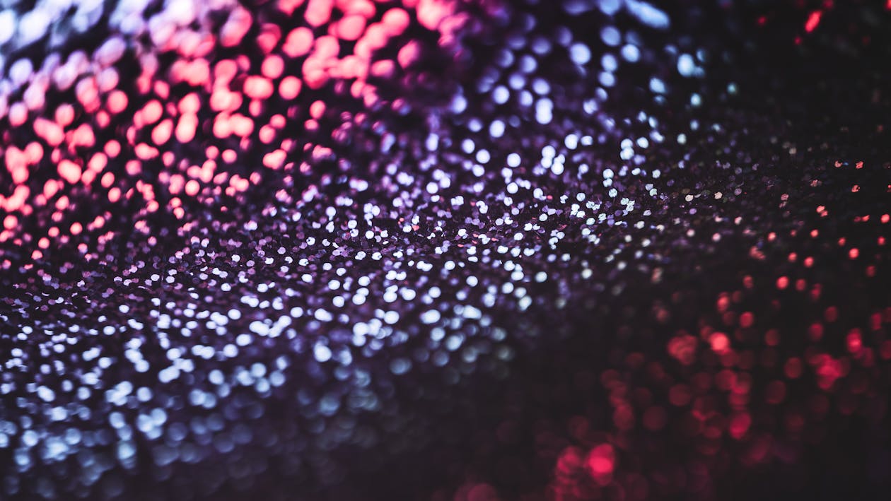 A close up of a black and red background with water droplets