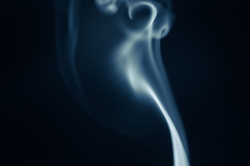 Free Elegant swirling smoke patterns set against a dark background, creating a mesmerizing abstract theme. Stock Photo