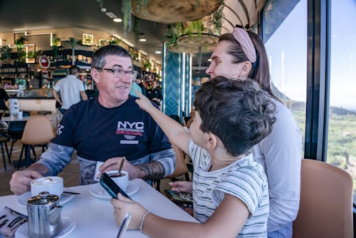 Free Mother, Father and Son Sitting by Table Stock Photo