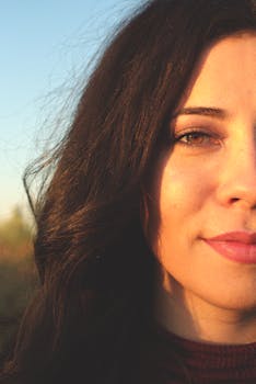 Half-face portrait showcasing natural beauty with soft lighting and clear skin.